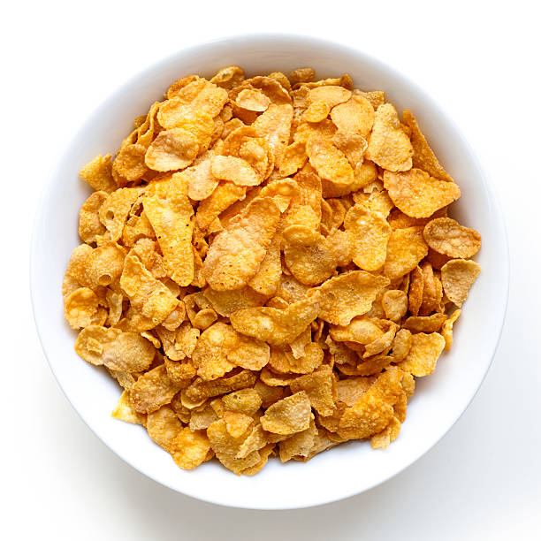 istock Bowl of dry cornflakes isolated on white from above. 604383462