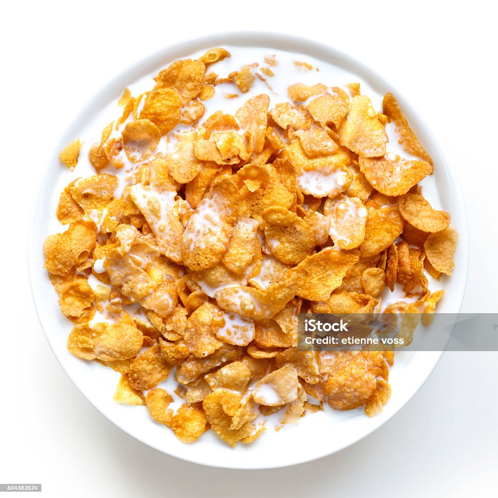 Bowl of cornflakes in milk isolated on white from above. Cereal Plant Stock Photo