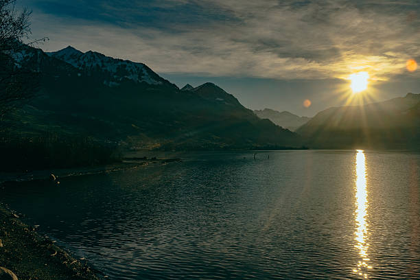 istock Calm Lake Against Mountain Range At Sunset 604388699