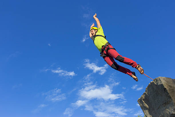 istock Jump rope from a high rock in the mountains. 604755946