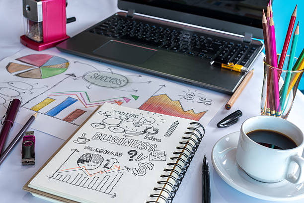 istock Office table with laptop, analyzing graphic, coffee cup/ business conceptual 604784936