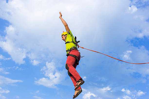 istock Jump rope from a high rock in the mountains. 604785420