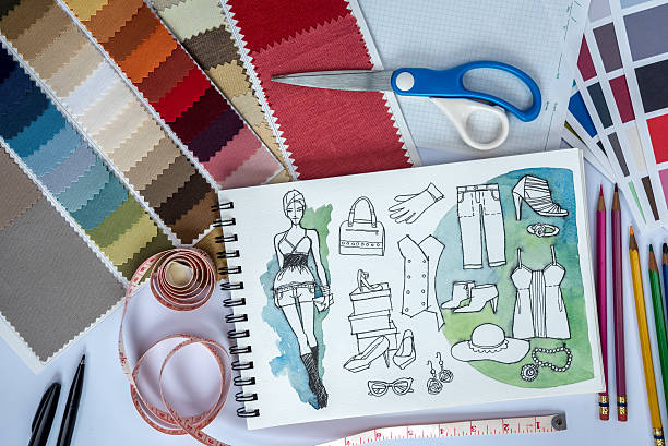 istock Fashion designer studio with sketch of clothes and samples 604795380