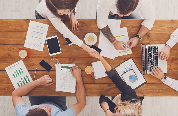 istock Business people group handshake in office, top view 604809020