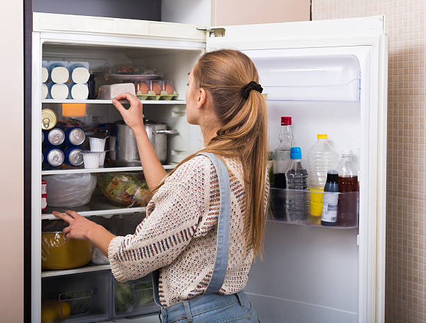 istock Housewife arranging products in fridge 604819478