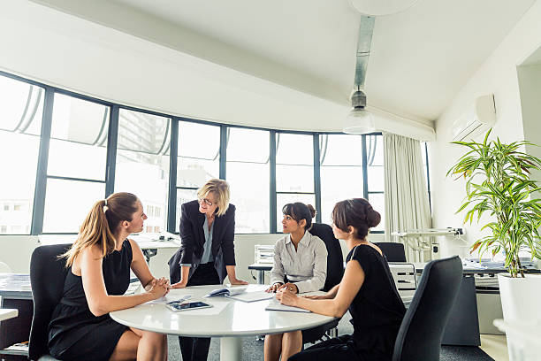 istock Businesswoman discussing with executives at office 604822614