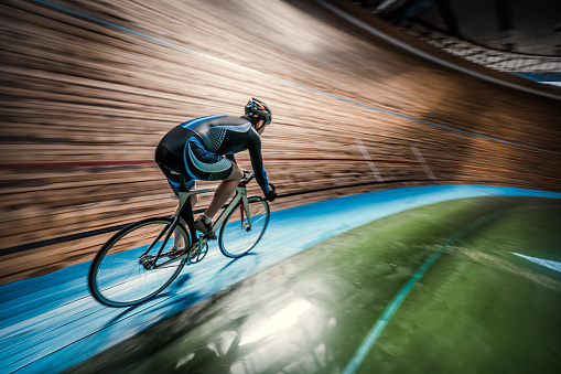 Athlete with a bicycle at velodrome