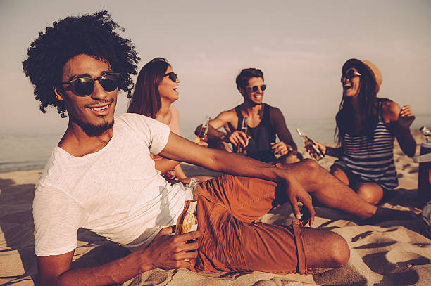 istock Enjoying beach party with friends. 604823690