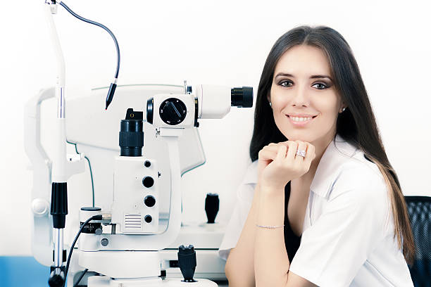 istock Optician with Sit Lamp Biomicroscope Instrument 604824188