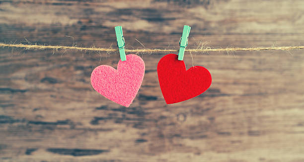 istock two red and  pink hearts hanging on a cord 604824336