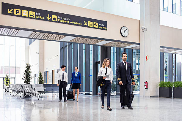 istock Pilots and flight attendants walking at the airport 604825826
