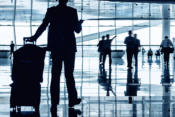 istock People reflection in  airport corridor 604826612