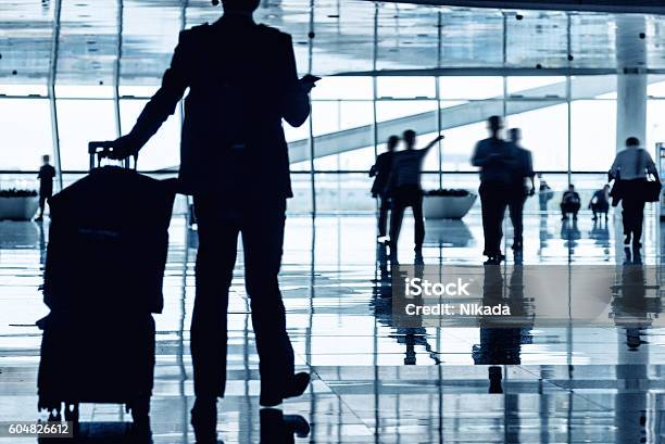 People Reflection In Airport Corridor Stock Photo - Download Image Now - Airport, Business, Carry-On Luggage