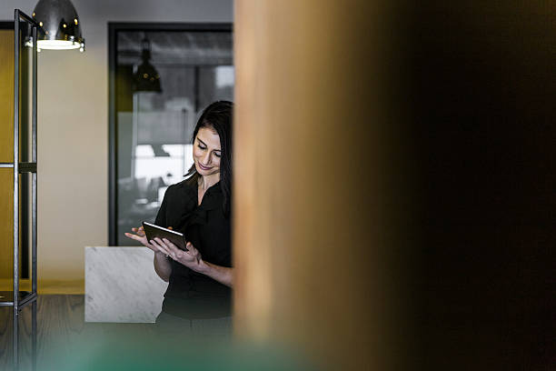 istock Businesswoman using digital tablet in office 604827984
