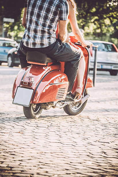 istock Couple Riding Red Vintage Scooter 604828412