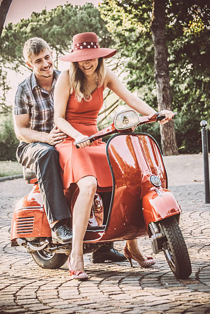 istock Young Couple Riding a Vintage Scooter 604828422