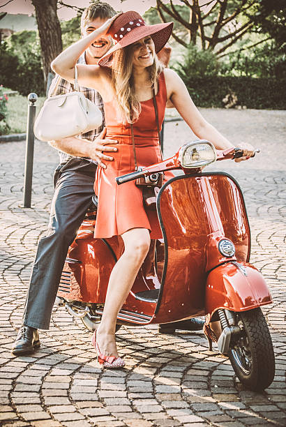 istock Young Couple Riding a Vintage Scooter 604828426