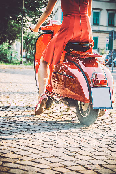 istock Young Woman Sitting On a Vintage Scooter 604828564