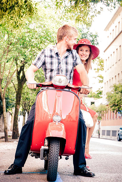 istock Young Couple Exploring the City on a Vintage Scooter 604828900