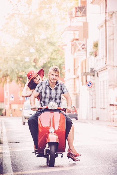 istock Young Couple Exploring the City on a Vintage Scooter 604828930