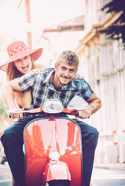 istock Young Couple Exploring the City on a Vintage Scooter 604829112