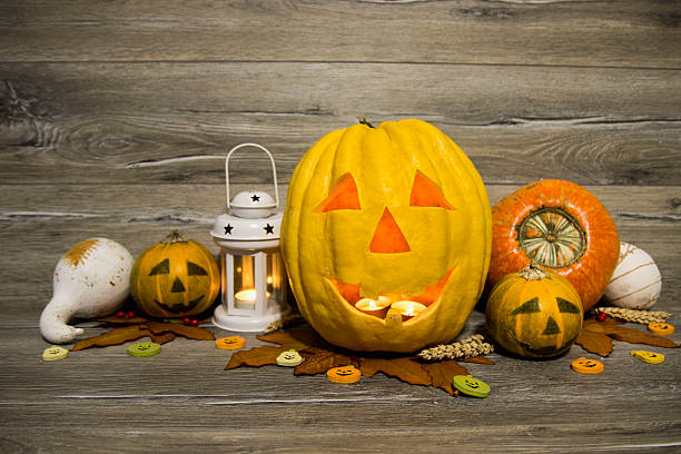 istock Halloween pumpkin head jack lantern on wooden background 604832194