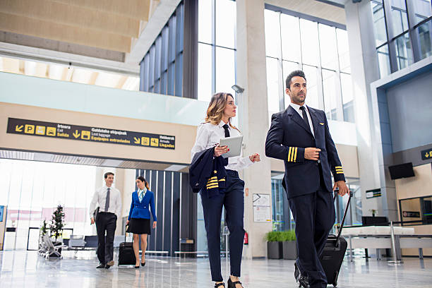 istock Pilots and flight attendants walking at the airport 604832196