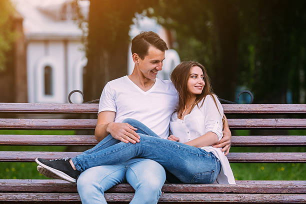 istock man and woman on a bench in the park 604857264