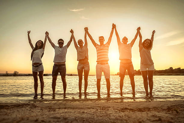 istock Silhouette of group young people on the beach. 604859376