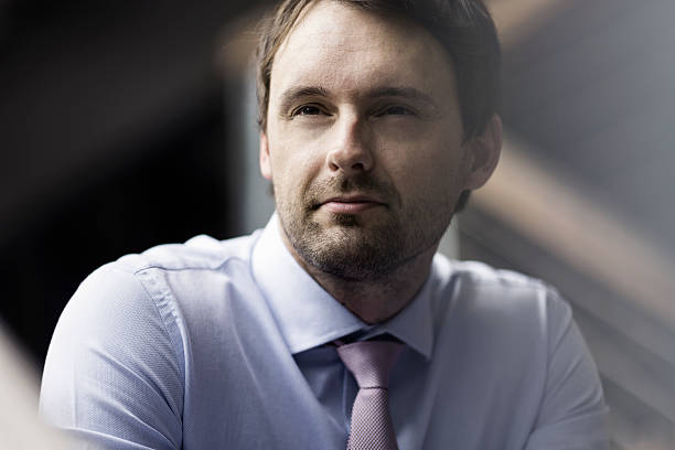 istock Thoughtful mid adult businessman looking away 604860656