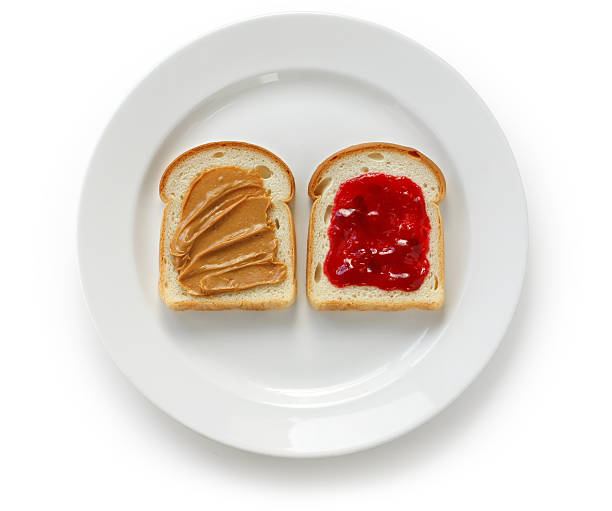 Grilled peanut butter and strawberry  jelly sandwich on a rustic background