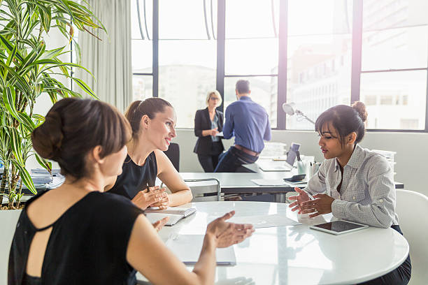 istock Businesswoman analysing document in meeting 604862244