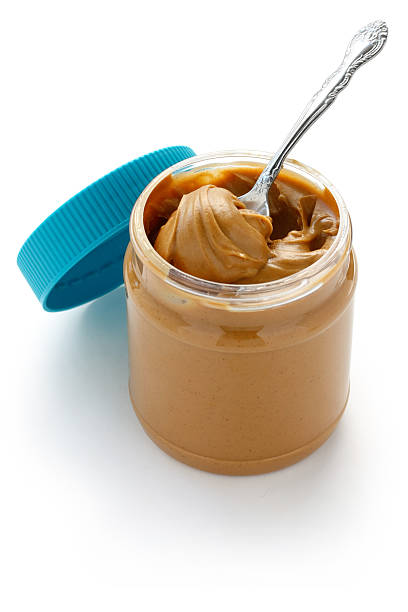 istock open jar of peanut butter with spoon 604863252