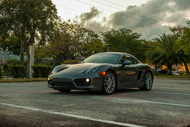 Full shot Porsche Cayman by night in residential area stock photo