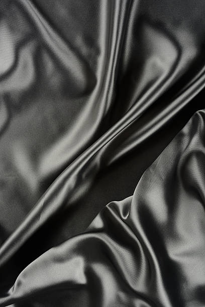 istock Effects of light in one gray satin fabric 604865558