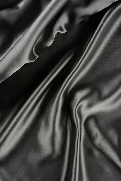 istock Effects of light in one gray satin fabric 604866172