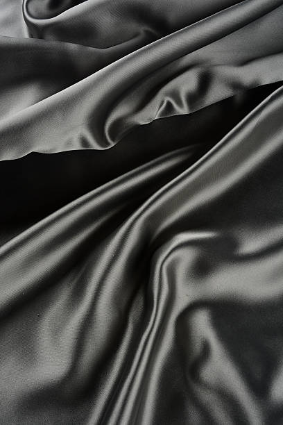 istock Effects of light in one gray satin fabric 604866730