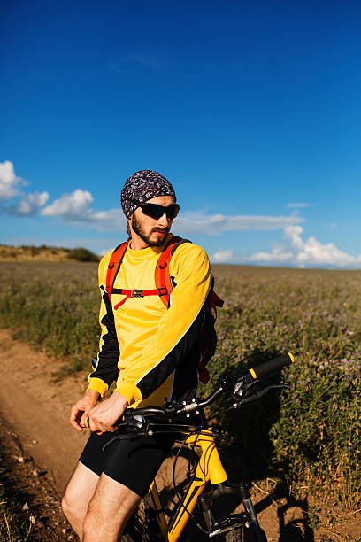 istock Young man cycling on a rural road 604867852