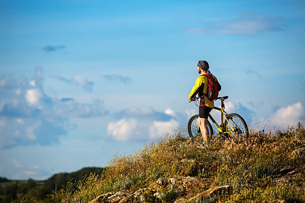 istock Young man cycling on a rural road 604869444