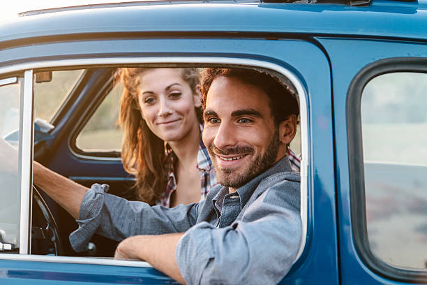 istock Loving couple in an old car 604896130