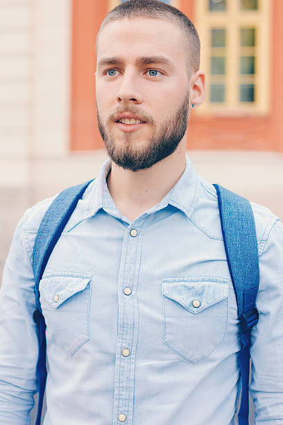 istock modern young bearded man on the streat, close up 604896418