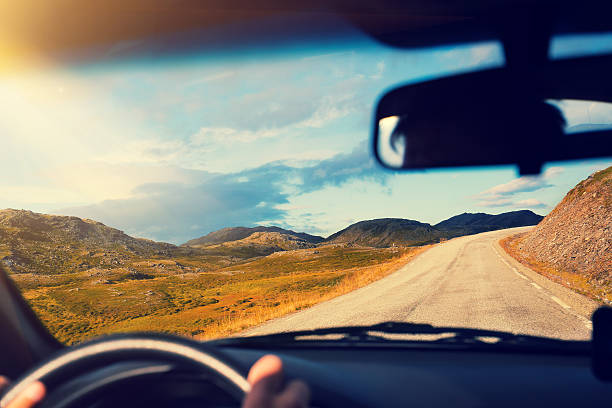 istock Driving a car on mountain road 604926064