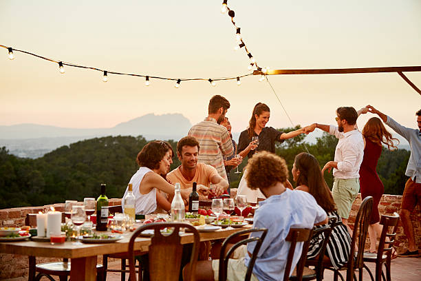 friends enjoying at patio during social gathering - adult beverage foto e immagini stock