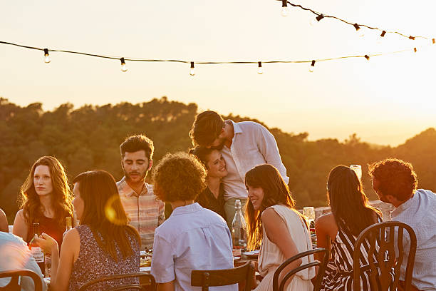 friends enjoying at dinner party - summer people furniture vacations foto e immagini stock