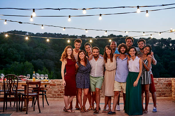 happy friends standing at patio during gathering - looking at camera full length outdoors image technique 뉴스 사진 이미지