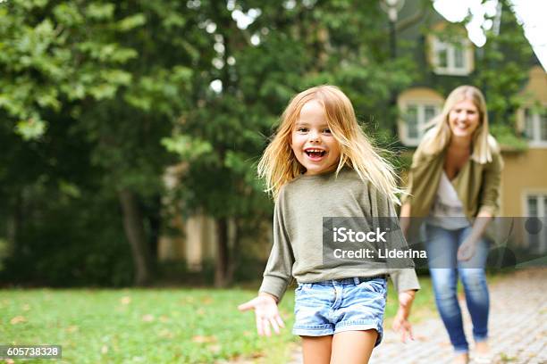 Mother Chasing Girl Outdoor Stock Photo - Download Image Now - Child, Family, Yard - Grounds