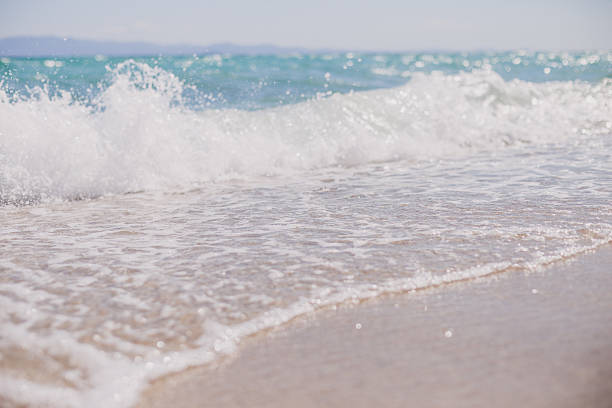 istock hard wave of ocean on the sandy beach 605739032