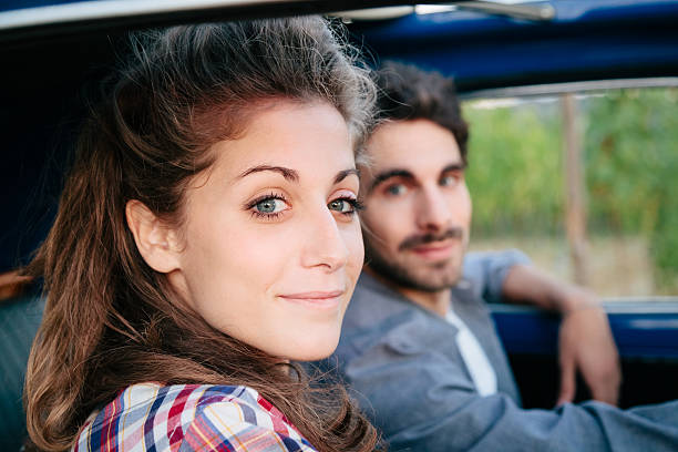 istock Loving couple in an old car 605739342