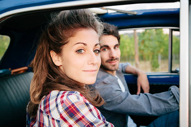 istock Loving couple in an old car 605739446