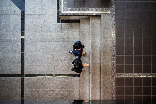 Aerial view of Asian business women entering and meeting in the lobby of modern office building in Kyoto, Japan